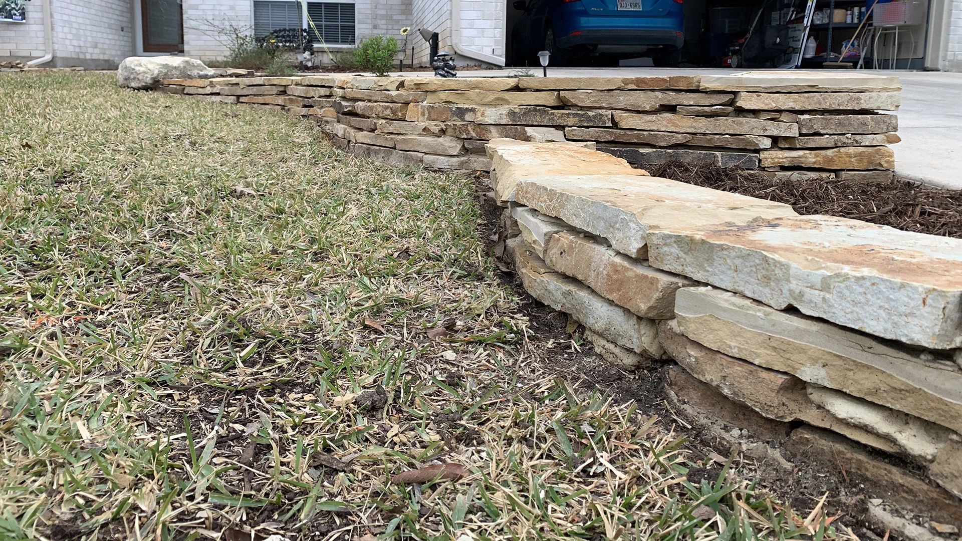 Close up on a stone retaining wall recently built on our client's property in Seguin, TX.