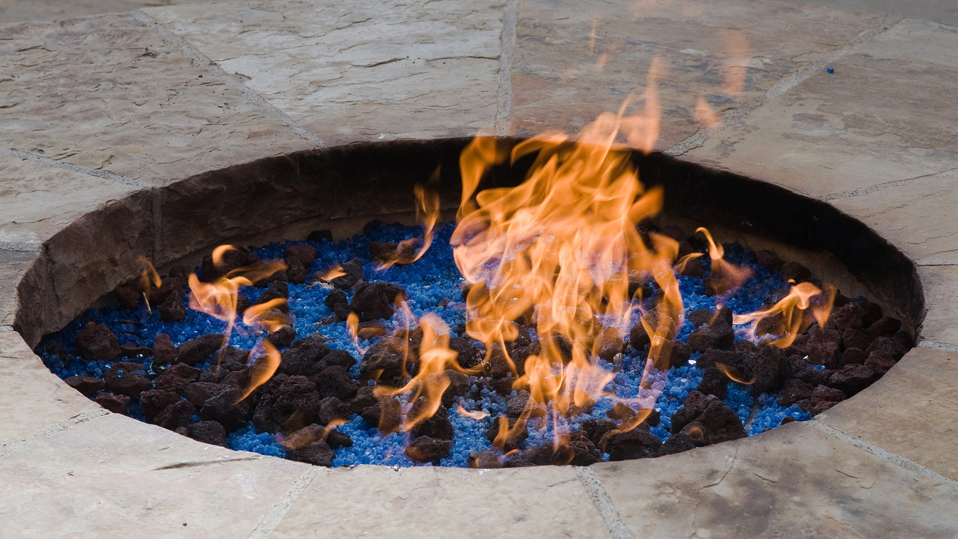 Close up on a lit fire pit installed on a property in Kyle, TX.