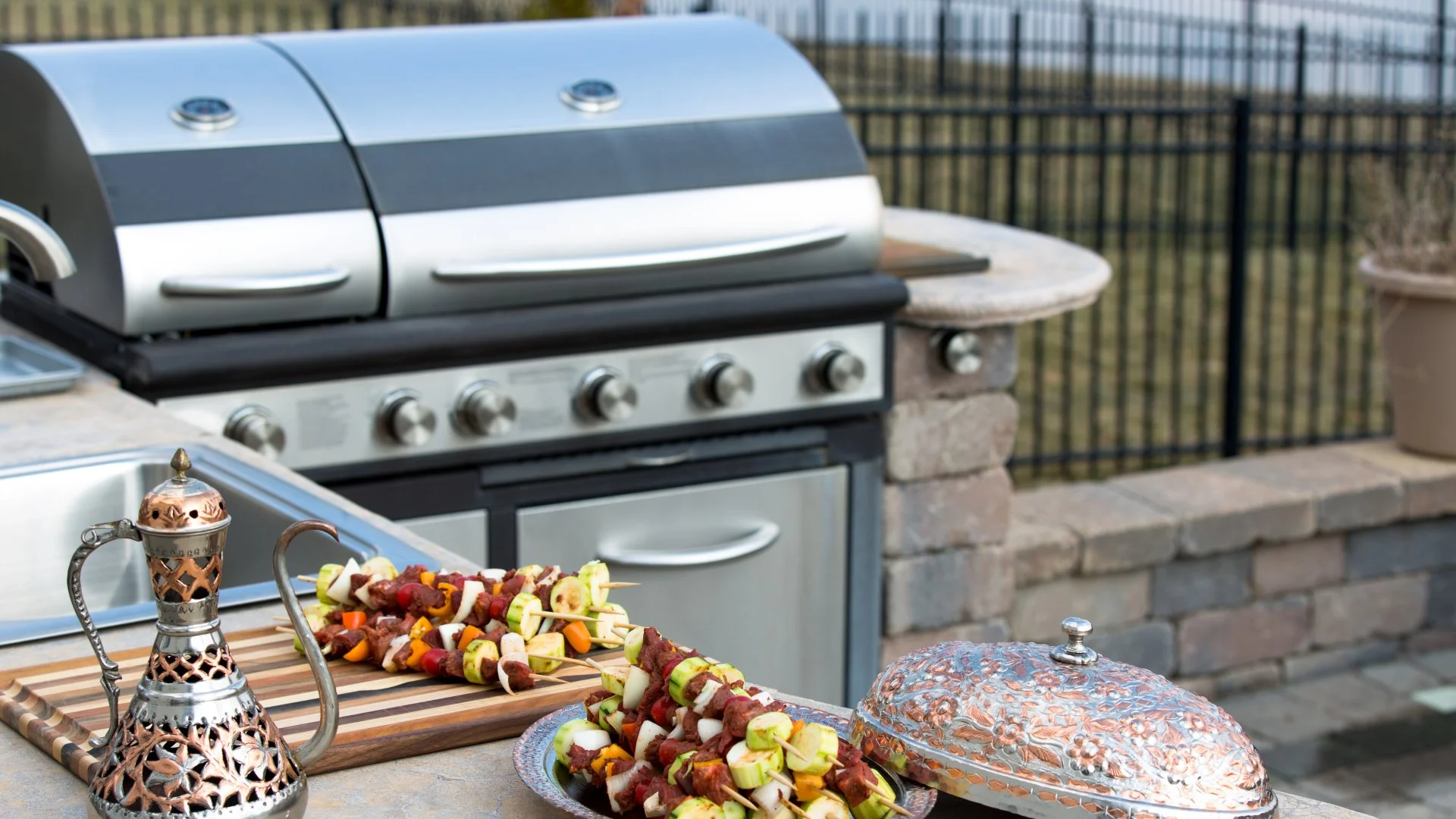 Grill and food on top of outdoor kitchen build in New Braunfels, TX.