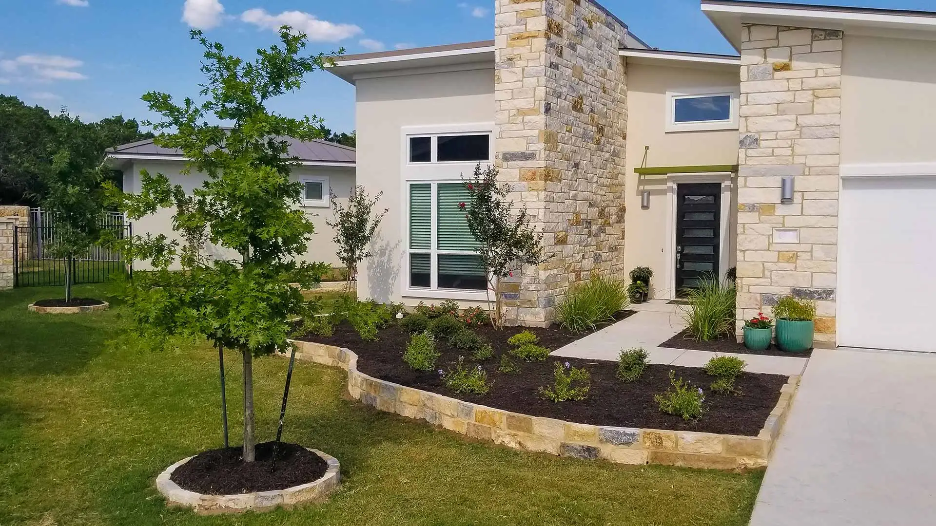 Landscape bed with dark mulch at a home near New Braunfels, TX.