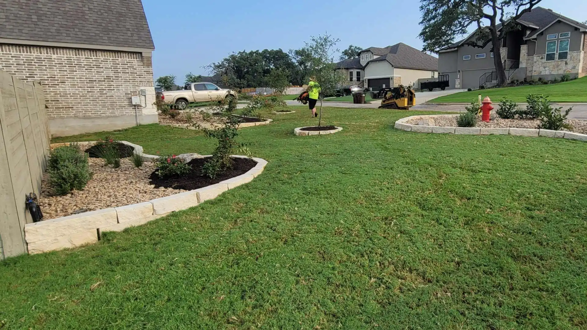 Lawn and landscape beds maintained by CLC professional in Canyon Lake, TX.