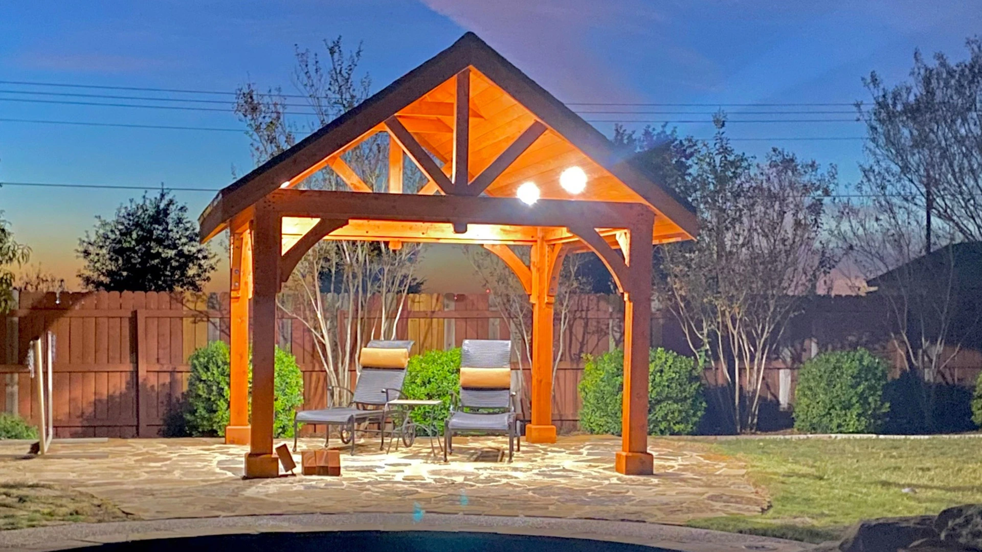 A pergola lit up in the evening thanks to our recently installed lighting in New Braunfels, TX.