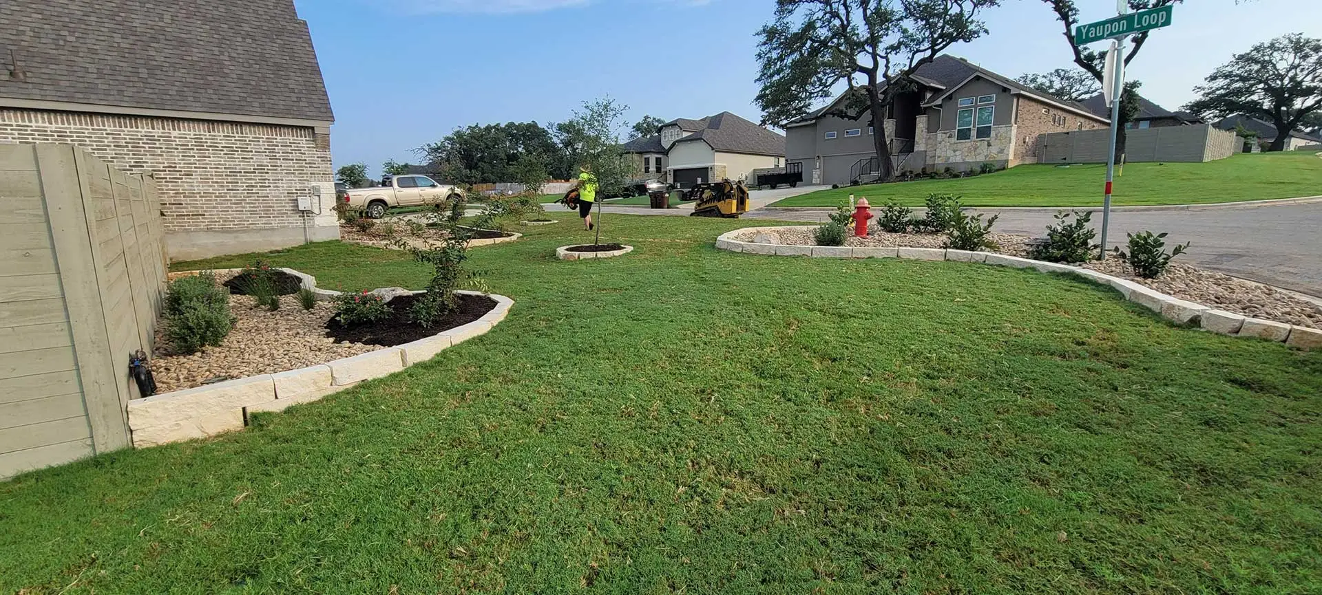 Panoramic photo of a yard with landscaping installations near New Braunfels, TX.