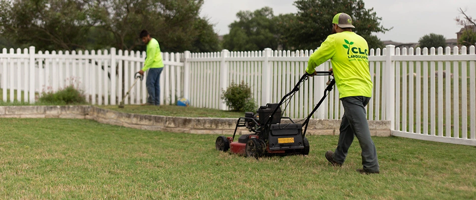 CLC workers mowing lawn in New Braunfels, TX.