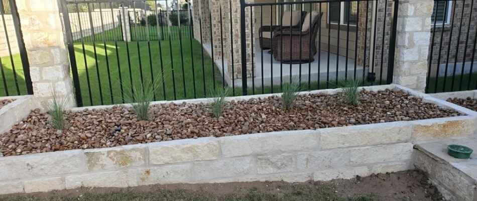 Landscape bed renovation with rock installed in New Braunfels, TX.
