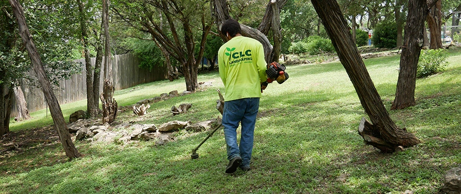 Our landscaper hard at work with a trimmer on a property in Buda, TX. 