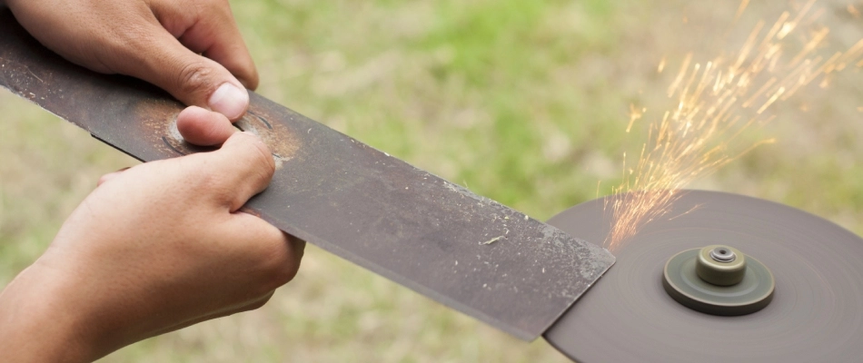 Professional sharpening mower blade in San Marcos, TX.