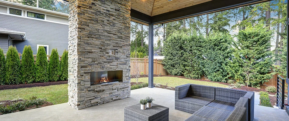 Gorgeously designed modern outdoor fireplace on a patio just outside in Buda, TX.