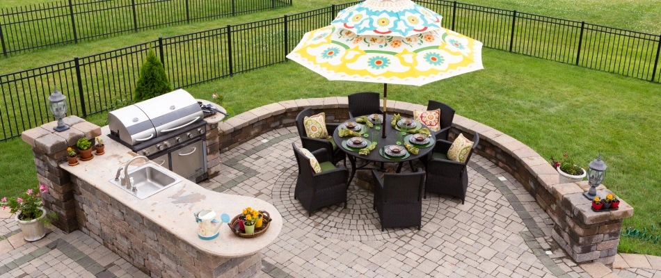 Outdoor kitchen with sink, counter tops, and grill installed in Kyle, TX.