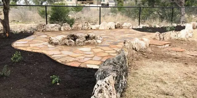 Custom patio built with stone and boulders at a home in New Braunfels, TX.