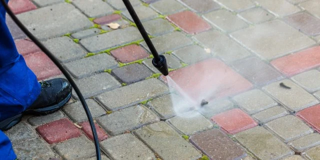 Pressure washing a paver walkway at a home in New Braunfels, TX.