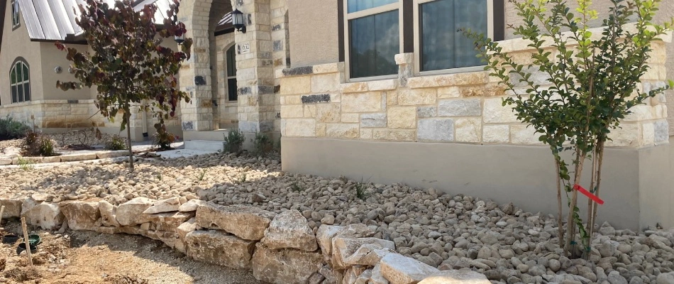 Rock ground covering for landscape bed in New Braunfels, TX.