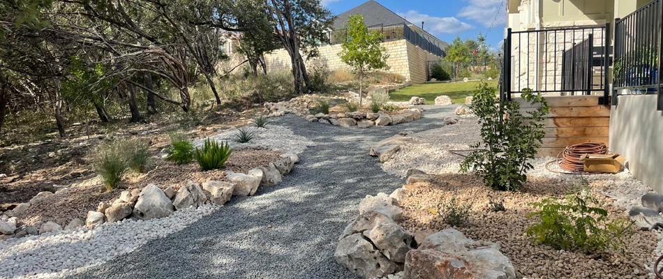 Plantings installed in rock landscape bed throughout landscape in San Marcos, TX.