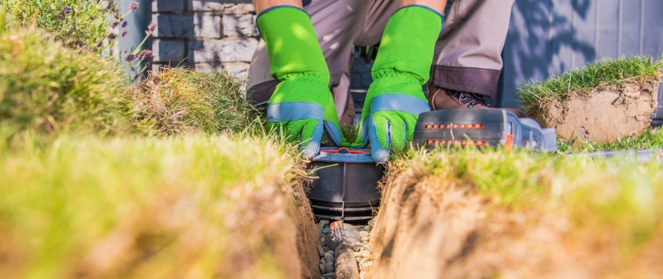 Specialist installing a new irrigation system in New Braunfels, TX.
