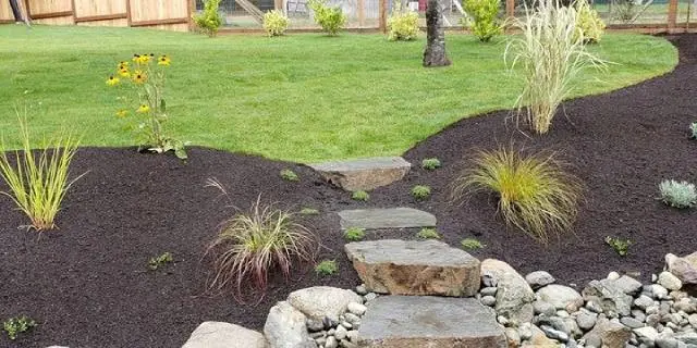 Landscape bed with custom walkway and plantings in Buda, TX.