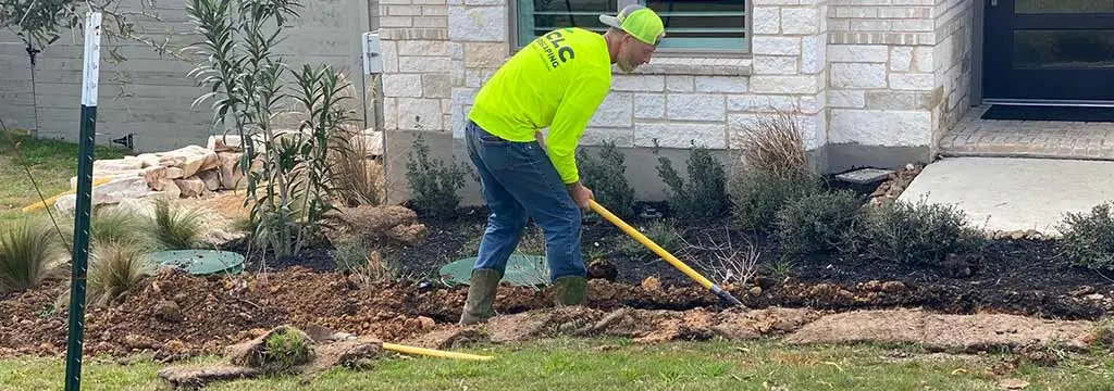 CLC Landscaping employee working on a landscape bed in San Marcos, TX.