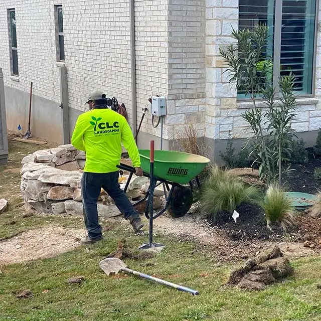 CLC Landscaping technician building a landscape bed around a home in New Braunfels, TX.