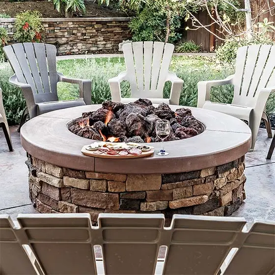 Natural stone fire pit and chairs at a home in New Braunfels, TX.