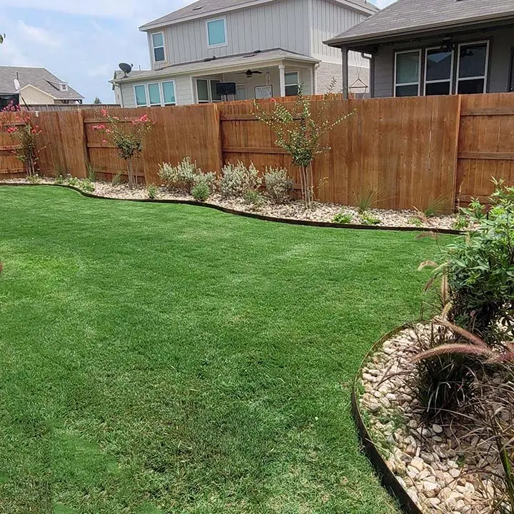 Lawn with landscape beds and plantings near New Braunfels, TX.